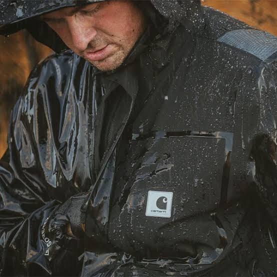 Carhartt hooded rain jacket with water droplets on the fabric